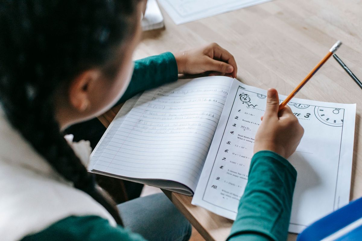 Tutor guiding a student through equations in a focused math session