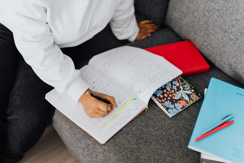 Engineering student studying thermal cycle calculations with organized notes